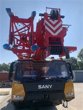 front view of red and yellow Sany SAC600E all terrain crane