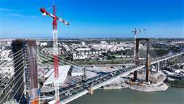 red and white Liebherr 420 EC-H 16 Litronic tower cranes on the Puente Quinto Centenario in Seville, Spain