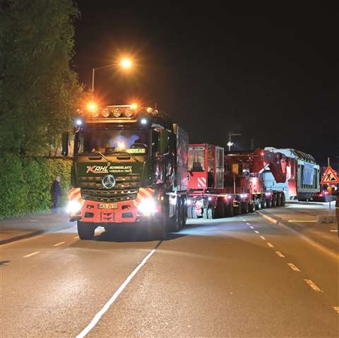 A transformer is moved via a a girder bridge and two tractor units